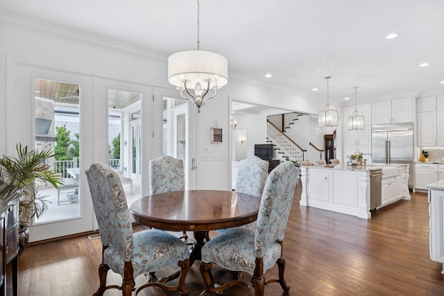 813 Stonewater Blvd, Franklin, TN 37064 - dining space featuring a chandelier, stairway, dark wood-type flooring, recessed lighting, and crown molding