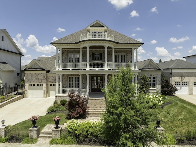 813 Stonewater Blvd, Franklin, TN 37064 - greek revival inspired property featuring french doors, driveway, covered porch, an attached garage, and a balcony