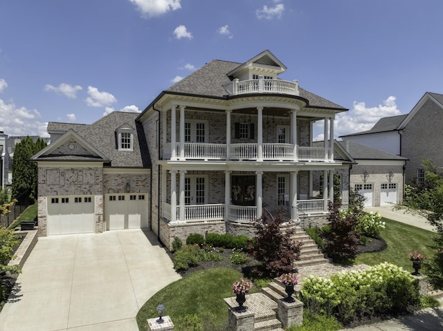 813 Stonewater Blvd, Franklin, TN 37064 - greek revival house with a balcony, covered porch, driveway, roof with shingles, and a garage