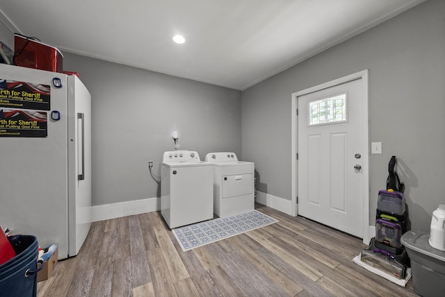 779 Dogwood Dr, Erin, TN 37061 - laundry room featuring washer and clothes dryer, wood finished floors, and recessed lighting
