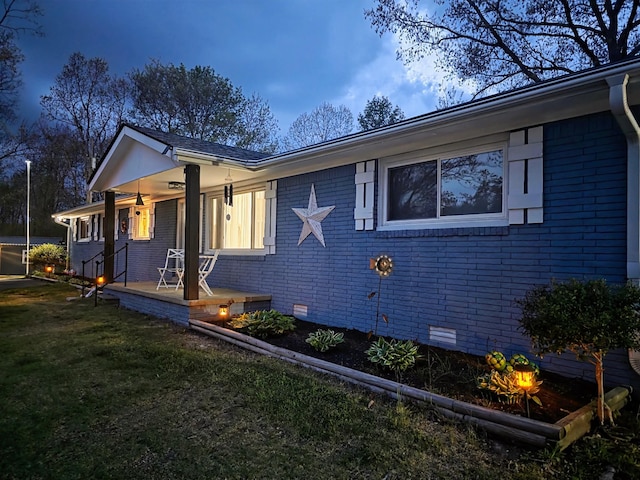 779 Dogwood Dr, Erin, TN 37061 - view of property exterior with a porch, brick siding, and a lawn