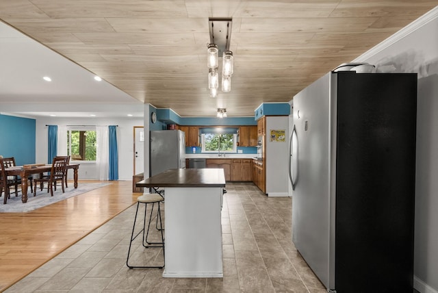 779 Dogwood Dr, Erin, TN 37061 - kitchen featuring stainless steel appliances, brown cabinets, recessed lighting, a kitchen island, and dark countertops