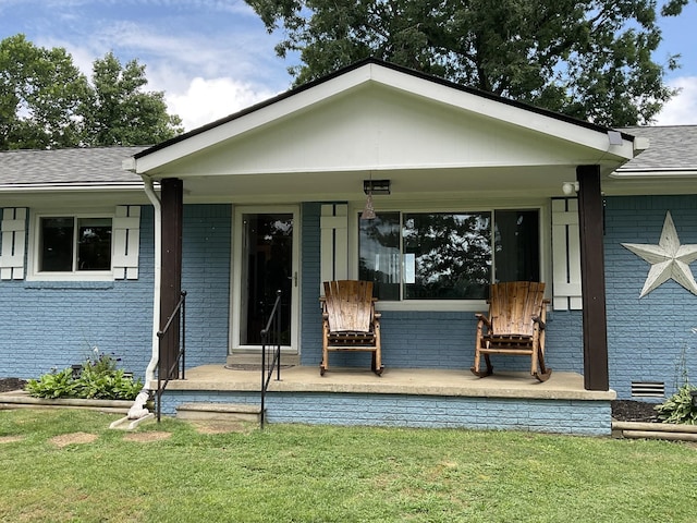 779 Dogwood Dr, Erin, TN 37061 - view of front facade featuring brick siding, a front yard, roof with shingles, and covered porch