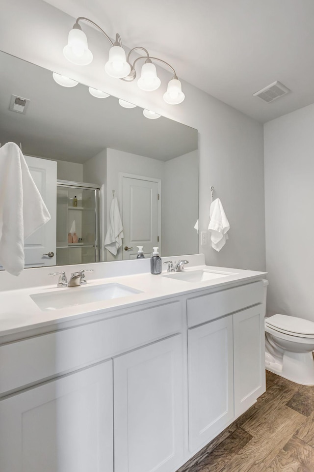 4112 Cadence Dr, Spring Hill, TN 37174 - bathroom with double vanity, a stall shower, and wood finished floors