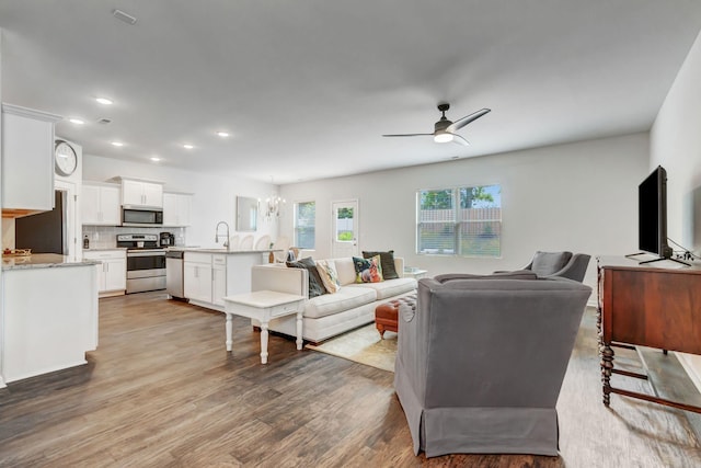 4112 Cadence Dr, Spring Hill, TN 37174 - living room with a ceiling fan, wood finished floors, recessed lighting, and a chandelier