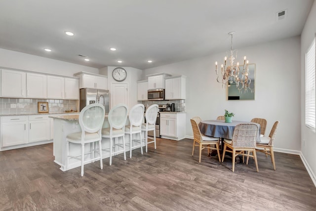 4112 Cadence Dr, Spring Hill, TN 37174 - dining area featuring a chandelier, wood finished floors, and recessed lighting