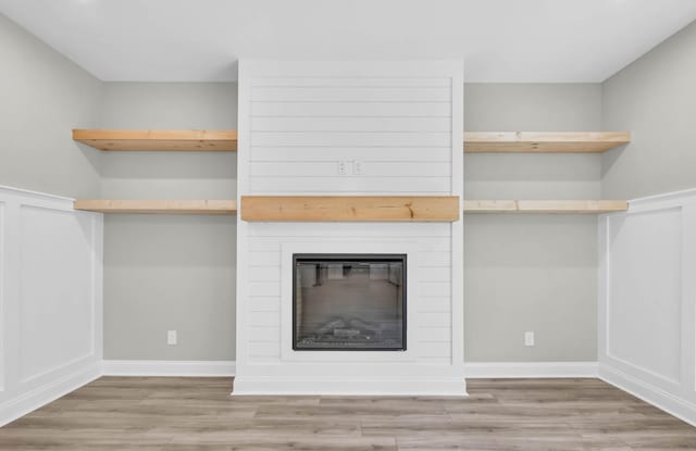 582 Pongracz Way, Clarksville, TN 37042 - unfurnished living room featuring wood finished floors and a large fireplace