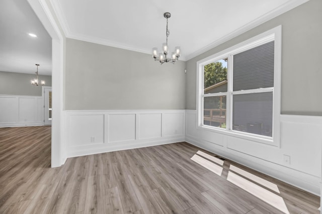 582 Pongracz Way, Clarksville, TN 37042 - spare room featuring a chandelier, ornamental molding, wood finished floors, a wainscoted wall, and a decorative wall