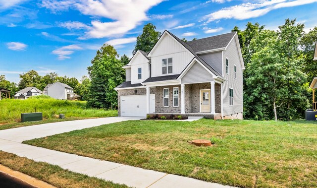 582 Pongracz Way, Clarksville, TN 37042 - view of front of home with concrete driveway, a garage, a front yard, and a porch