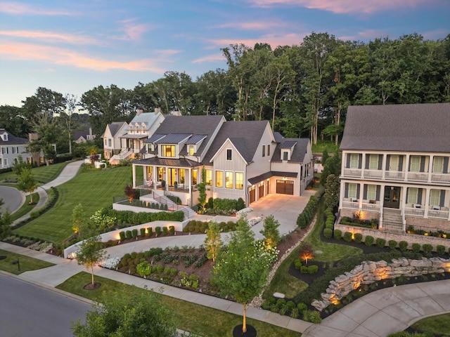 8227 Heirloom Blvd, College Grove, TN 37046 - view of front facade featuring driveway, a balcony, a porch, board and batten siding, and a front lawn