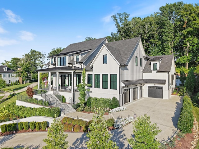 8227 Heirloom Blvd, College Grove, TN 37046 - modern farmhouse with a standing seam roof, a garage, concrete driveway, stairs, and roof with shingles