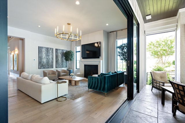 8227 Heirloom Blvd, College Grove, TN 37046 - living room with a chandelier, a fireplace, light wood-style flooring, and recessed lighting