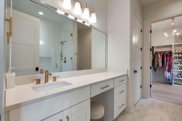 8227 Heirloom Blvd, College Grove, TN 37046 - bathroom featuring a stall shower, vanity, a spacious closet, marble look tile flooring, and a chandelier