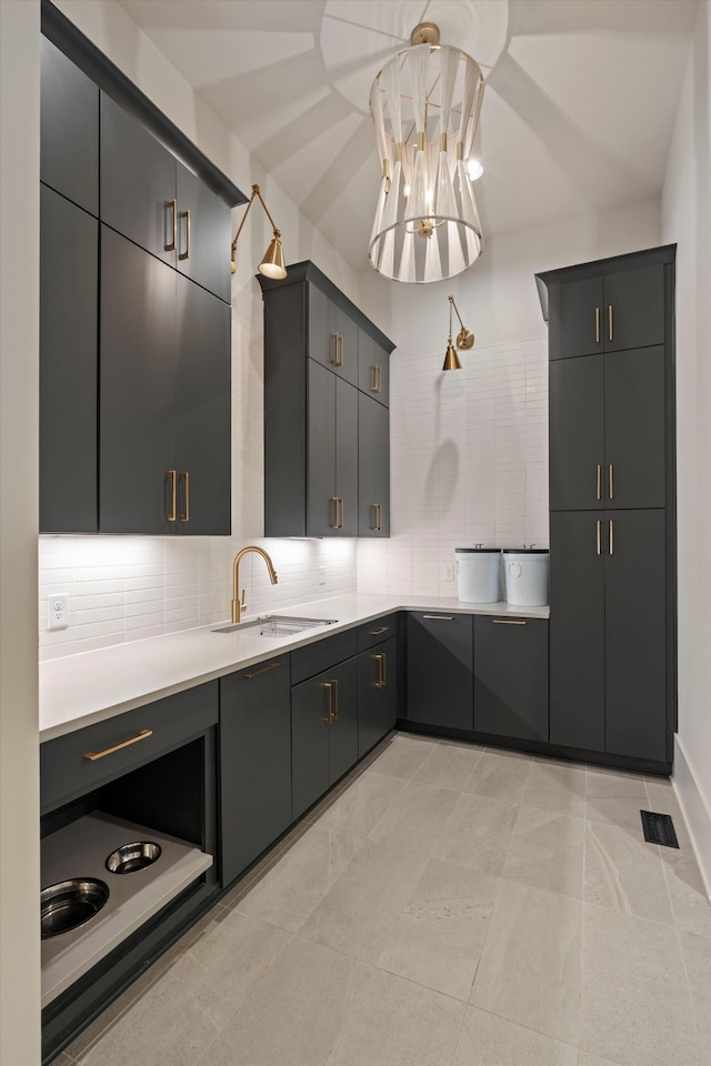 8227 Heirloom Blvd, College Grove, TN 37046 - kitchen featuring decorative backsplash, light countertops, decorative light fixtures, a chandelier, and light tile patterned floors