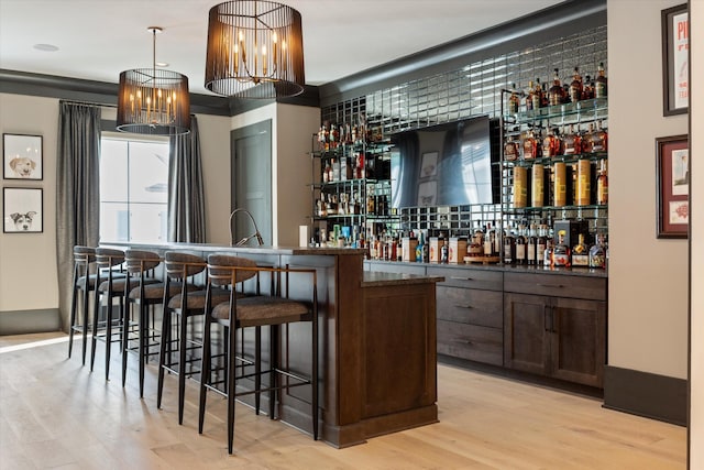 8227 Heirloom Blvd, College Grove, TN 37046 - community bar area with light wood-type flooring, a chandelier, and pendant lighting