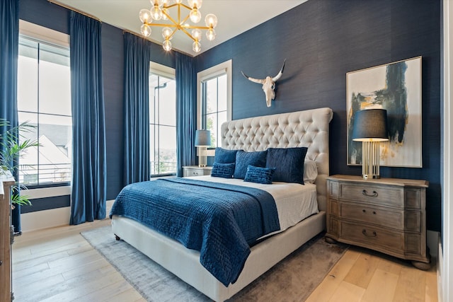 8227 Heirloom Blvd, College Grove, TN 37046 - bedroom featuring light wood-type flooring, a chandelier, and multiple windows