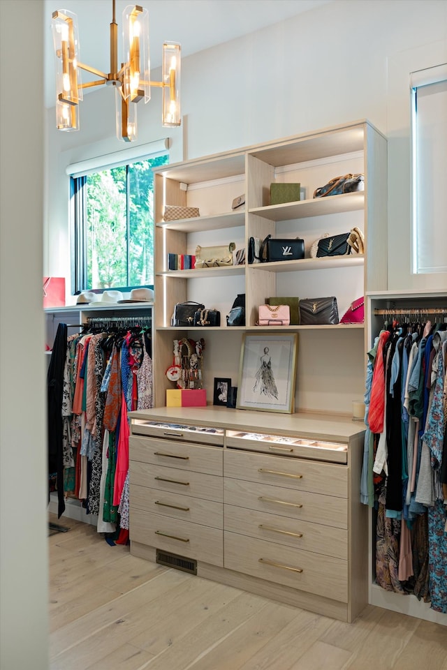 8227 Heirloom Blvd, College Grove, TN 37046 - walk in closet featuring a chandelier and light wood-type flooring