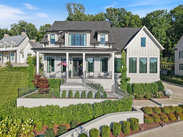 8227 Heirloom Blvd, College Grove, TN 37046 - view of front of property featuring a standing seam roof, board and batten siding, roof with shingles, a porch, and a metal roof