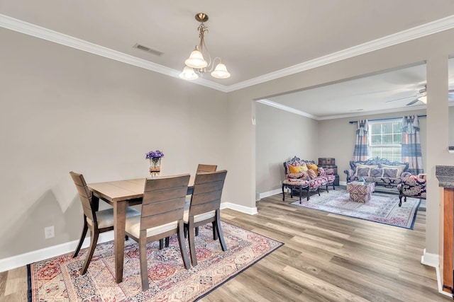 4835 Octavia St, Murfreesboro, TN 37129 - dining room with light wood-style floors, ornamental molding, a chandelier, and a ceiling fan