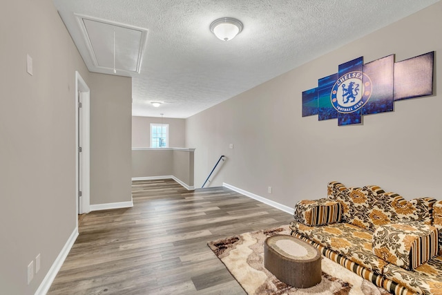 4835 Octavia St, Murfreesboro, TN 37129 - sitting room featuring attic access, a textured ceiling, wood finished floors, and an upstairs landing