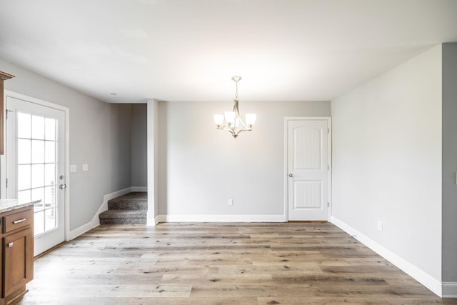 2075 Downstream Dr, Ashland City, TN 37015 - unfurnished dining area with a chandelier and light wood-type flooring