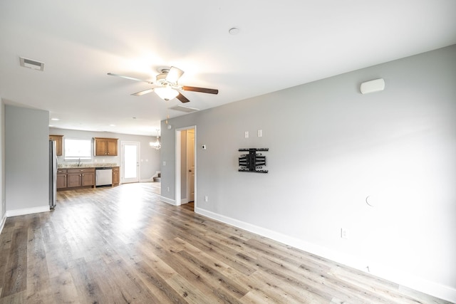 2075 Downstream Dr, Ashland City, TN 37015 - unfurnished living room featuring a ceiling fan and light wood-style floors