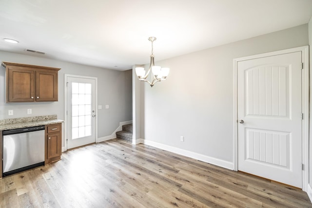 2075 Downstream Dr, Ashland City, TN 37015 - kitchen with dishwasher, a chandelier, light wood finished floors, brown cabinetry, and light stone countertops