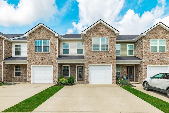 2075 Downstream Dr, Ashland City, TN 37015 - view of property featuring driveway, a garage, and roof with shingles
