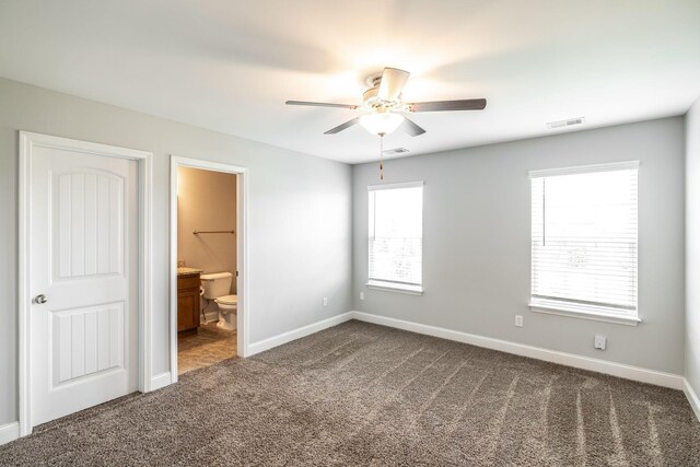 2075 Downstream Dr, Ashland City, TN 37015 - unfurnished bedroom with dark colored carpet, ensuite bathroom, and ceiling fan