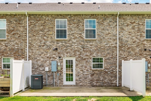 2075 Downstream Dr, Ashland City, TN 37015 - back of property featuring a patio area, brick siding, and roof with shingles