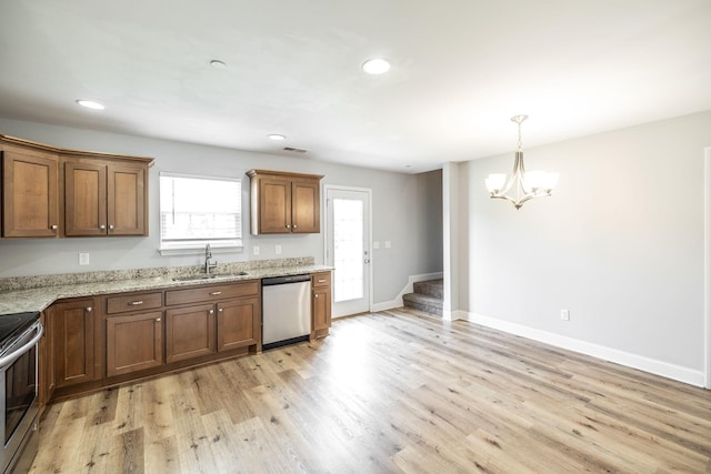 2075 Downstream Dr, Ashland City, TN 37015 - kitchen with appliances with stainless steel finishes, a chandelier, light wood-style floors, recessed lighting, and light stone countertops