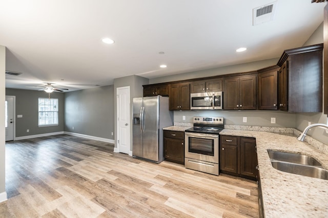 2071 Downstream Dr, Ashland City, TN 37015 - kitchen featuring stainless steel appliances, dark brown cabinets, light wood-style flooring, ceiling fan, and recessed lighting
