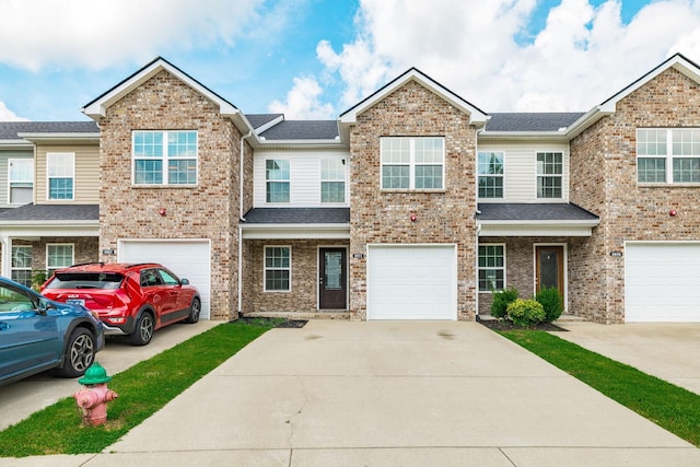 2071 Downstream Dr, Ashland City, TN 37015 - view of property with driveway, an attached garage, brick siding, and roof with shingles