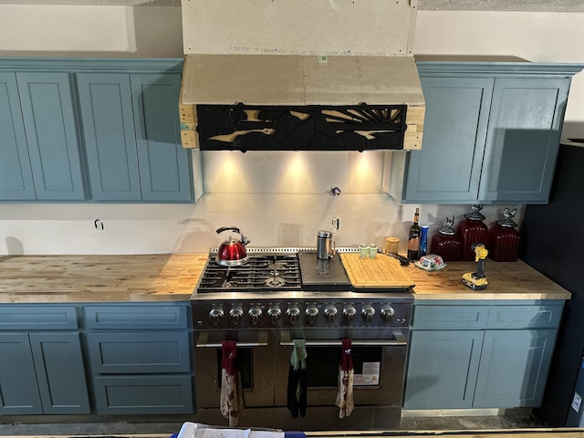 201 Summit Dr, Linden, TN 37096 - kitchen with double oven range, ventilation hood, blue cabinets, and butcher block counters
