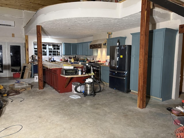 201 Summit Dr, Linden, TN 37096 - kitchen featuring black appliances, blue cabinets, a wall mounted AC, wall chimney range hood, and concrete floors