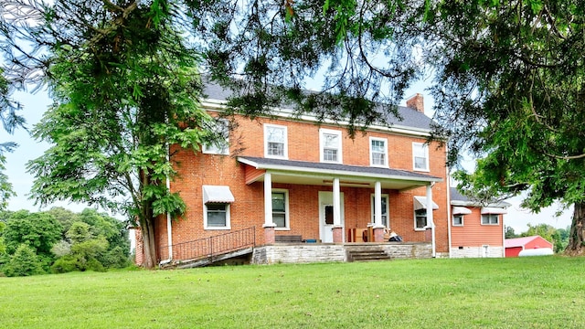 857 Davenport Rd, Cumberland City, TN 37050 - view of front of home featuring covered porch, a front lawn, a chimney, and brick siding