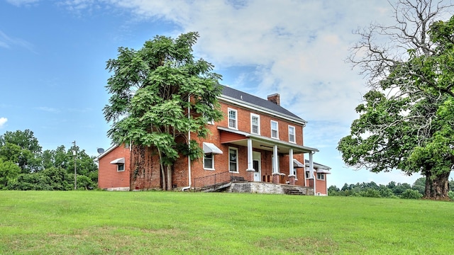 857 Davenport Rd, Cumberland City, TN 37050 - view of front facade featuring a porch, a front yard, a chimney, and brick siding