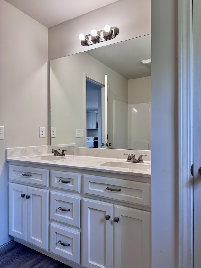 1122 Brannon Rd, Lawrenceburg, TN 38464 - bathroom featuring double vanity and wood finished floors