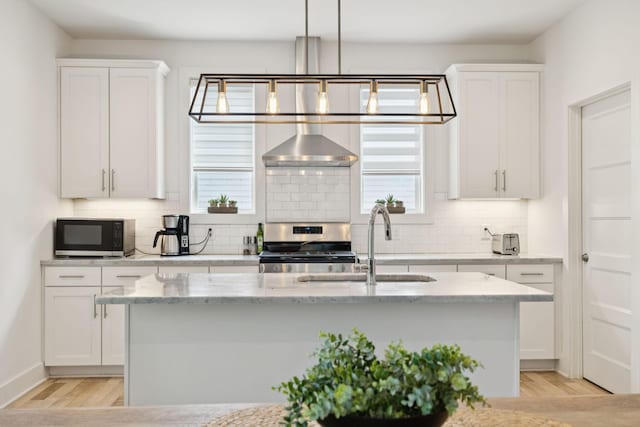 1111 Baptist World Center Dr Unit 5, Nashville, TN 37207 - kitchen with wall chimney exhaust hood, stainless steel electric range, light wood-style floors, and tasteful backsplash