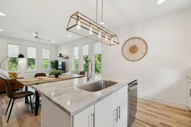 1111 Baptist World Center Dr Unit 5, Nashville, TN 37207 - kitchen with stainless steel dishwasher, open floor plan, recessed lighting, light wood-type flooring, and decorative light fixtures
