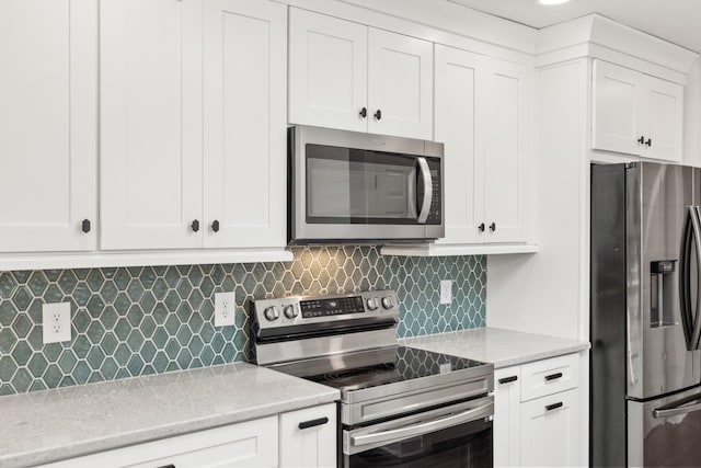8205 Brownstone Ext, Cross Plains, TN 37049 - kitchen featuring stainless steel appliances, backsplash, and white cabinetry