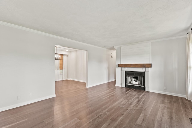 8205 Brownstone Ext, Cross Plains, TN 37049 - unfurnished living room with dark wood-style flooring, crown molding, a large fireplace, and a chandelier