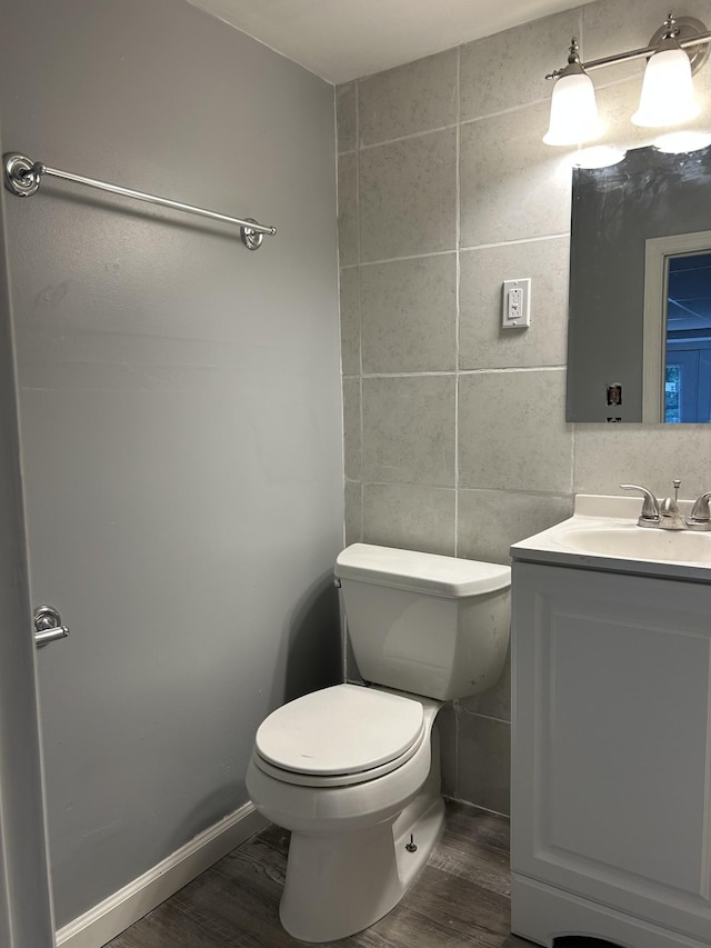 716 Muskhogean Ct, Antioch, TN 37013 - half bath featuring wood finished floors, vanity, tile walls, and backsplash