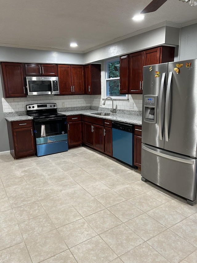 716 Muskhogean Ct, Antioch, TN 37013 - kitchen with stainless steel appliances, decorative backsplash, light stone countertops, light tile patterned floors, and ceiling fan