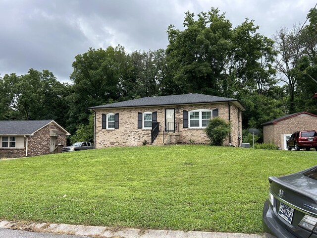 716 Muskhogean Ct, Antioch, TN 37013 - single story home featuring a front lawn, brick siding, and view of wooded area