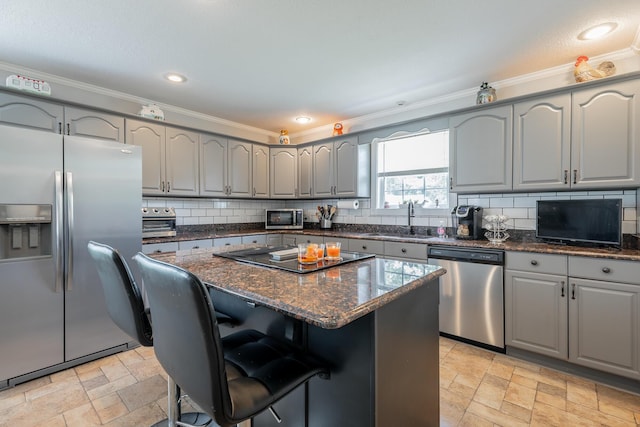 78 Gray Rd, Signal Mountain, TN 37377 - kitchen featuring appliances with stainless steel finishes, gray cabinetry, stone tile flooring, crown molding, and tasteful backsplash