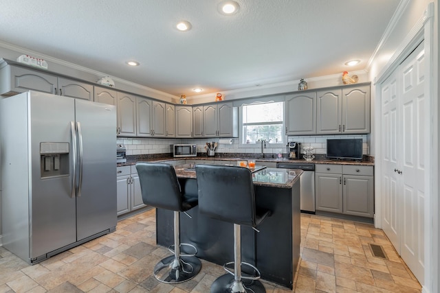 78 Gray Rd, Signal Mountain, TN 37377 - kitchen featuring stainless steel appliances, gray cabinetry, ornamental molding, stone tile floors, and a center island