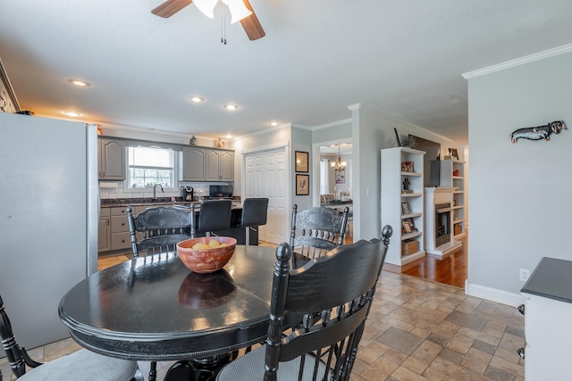 78 Gray Rd, Signal Mountain, TN 37377 - dining room with crown molding, a ceiling fan, stone tile floors, recessed lighting, and a chandelier