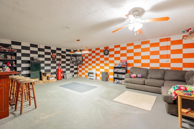 78 Gray Rd, Signal Mountain, TN 37377 - living area with wallpapered walls, ceiling fan, and concrete flooring