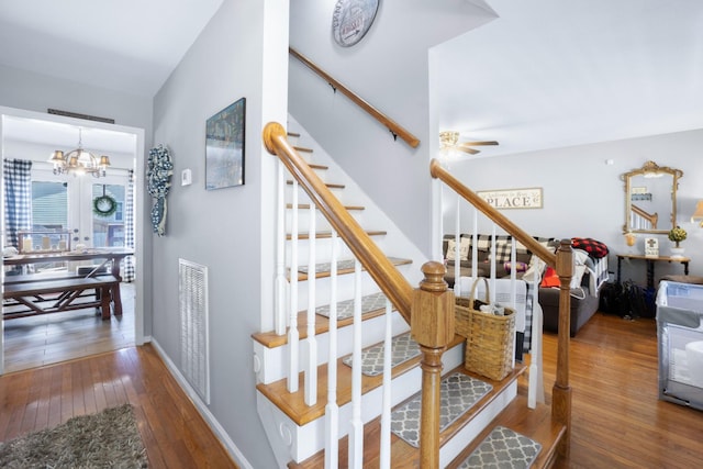 8202 Iris Rd, Chattanooga, TN 37421 - staircase featuring hardwood / wood-style flooring, a chandelier, and a ceiling fan